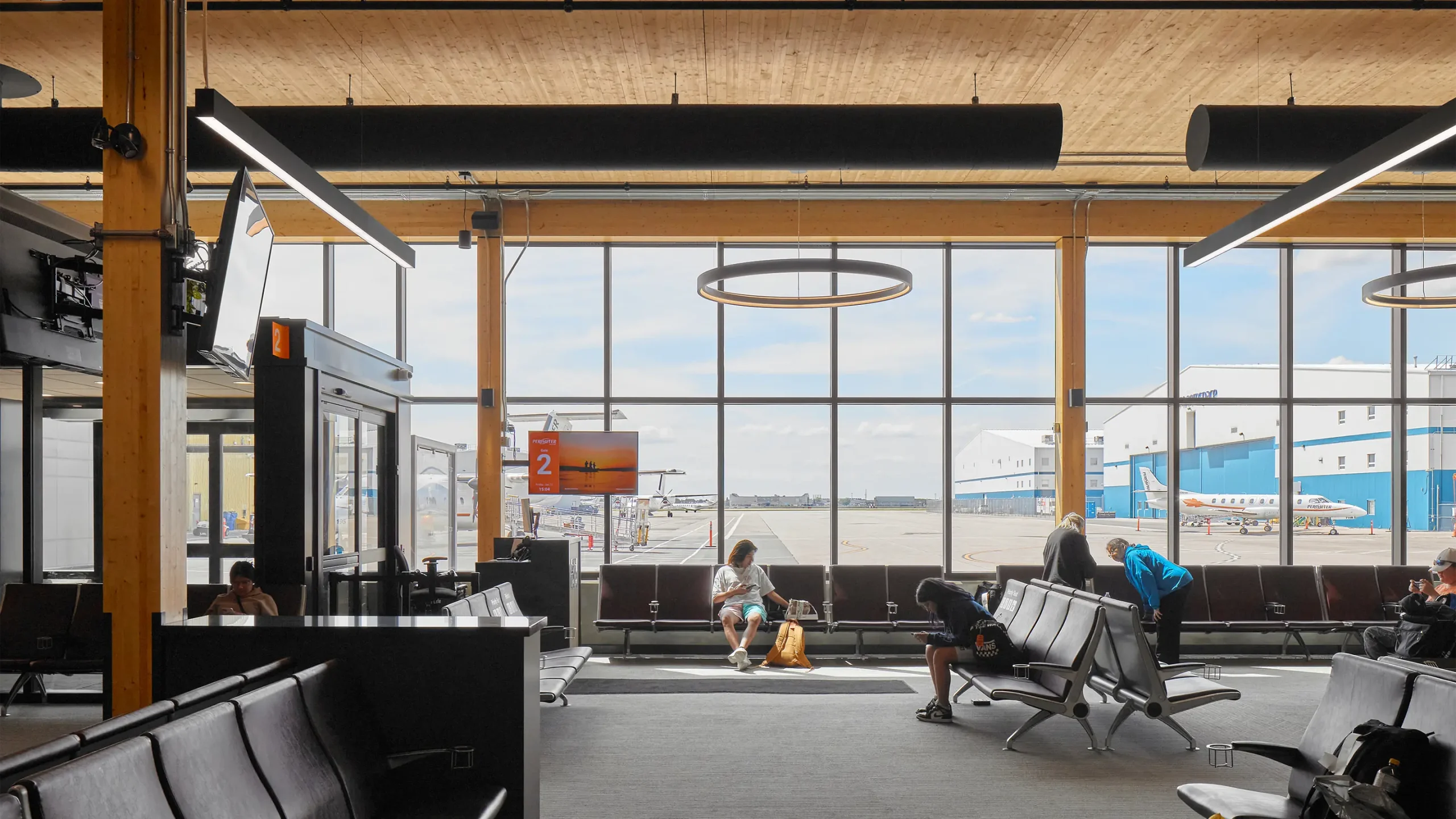 Interior of terminal waiting area with view of runways out large windows