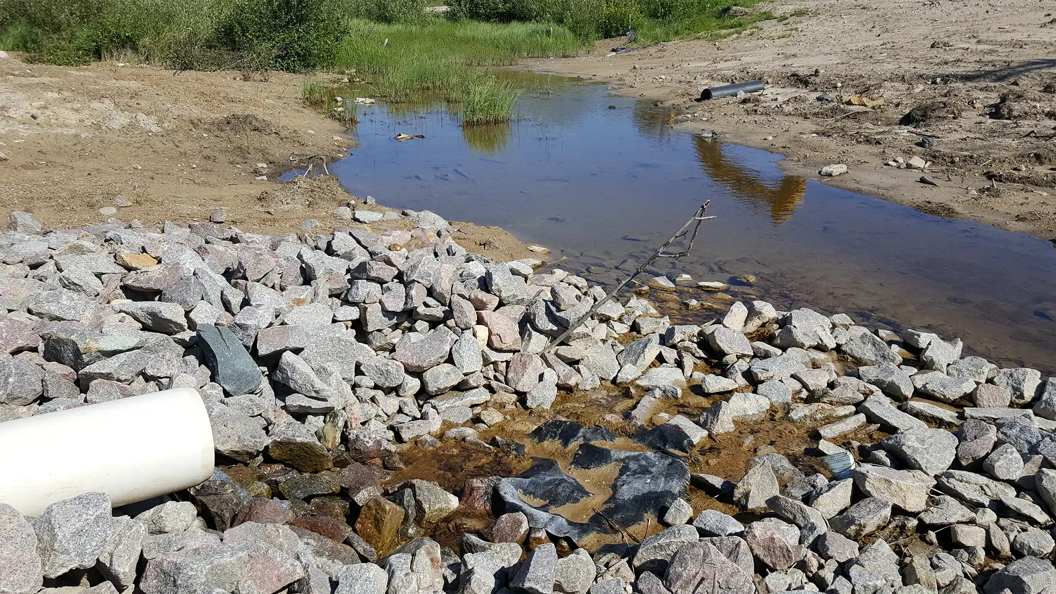 Drainage via pipe onto rocks