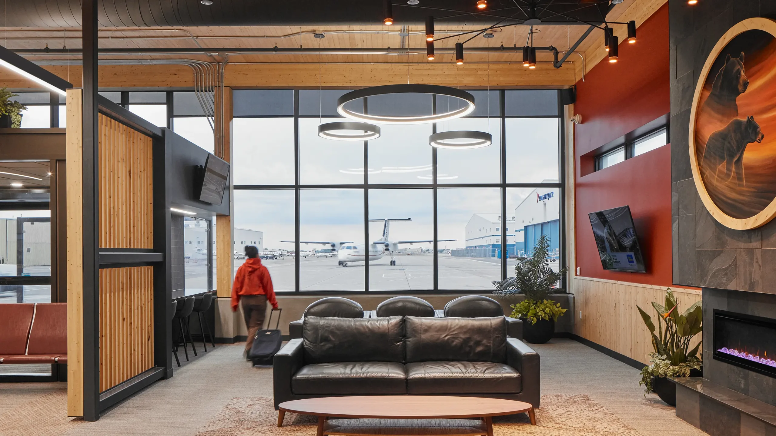 Interior of terminal waiting area with view of runways out large windows