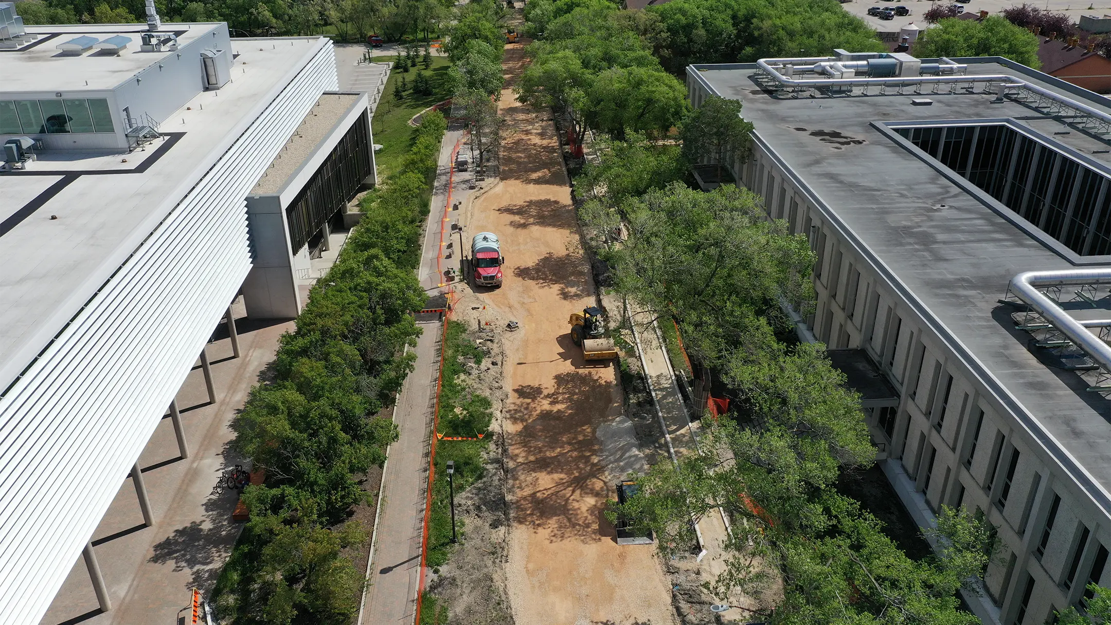 Aerial view of road construction between buildings