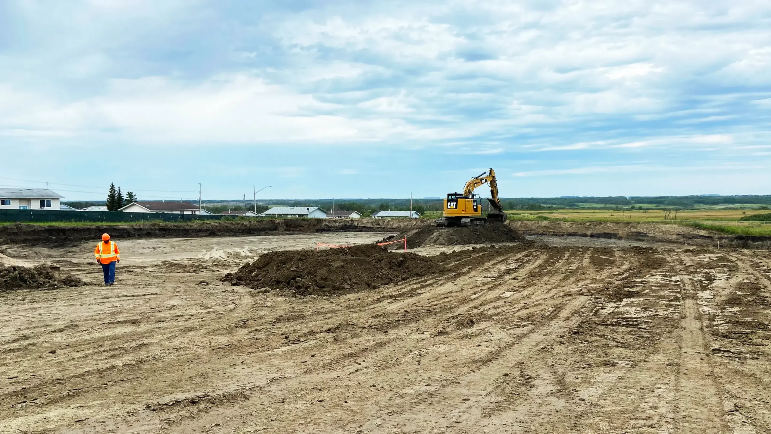 An excavator digs up dirt at the remediation site