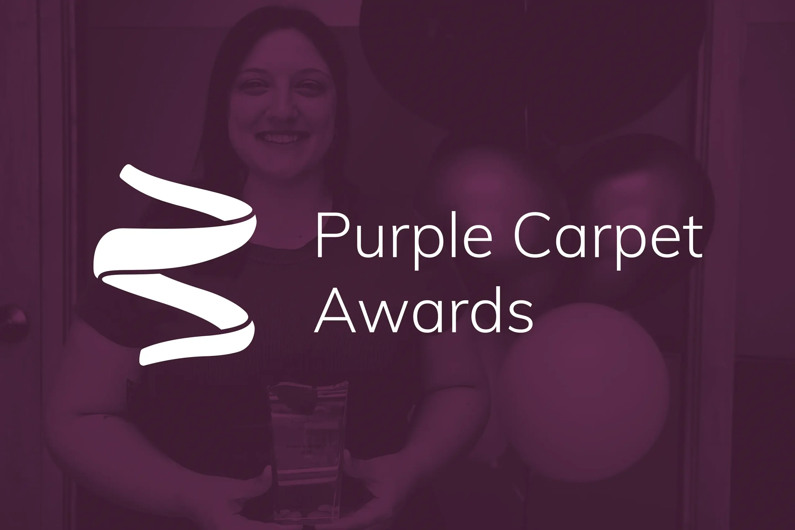 A purple‑tinted photograph of a KGS Group employee happily receiving an award, accompanied by the title: Purple Carpet Awards.
