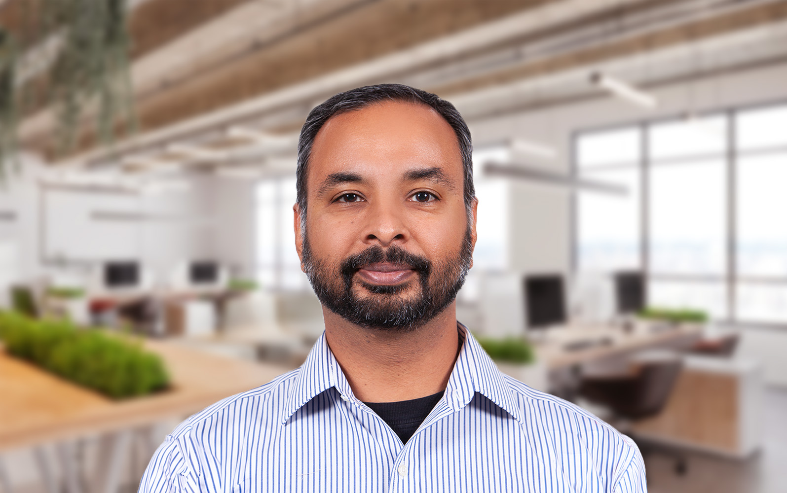 Man standing in office space.