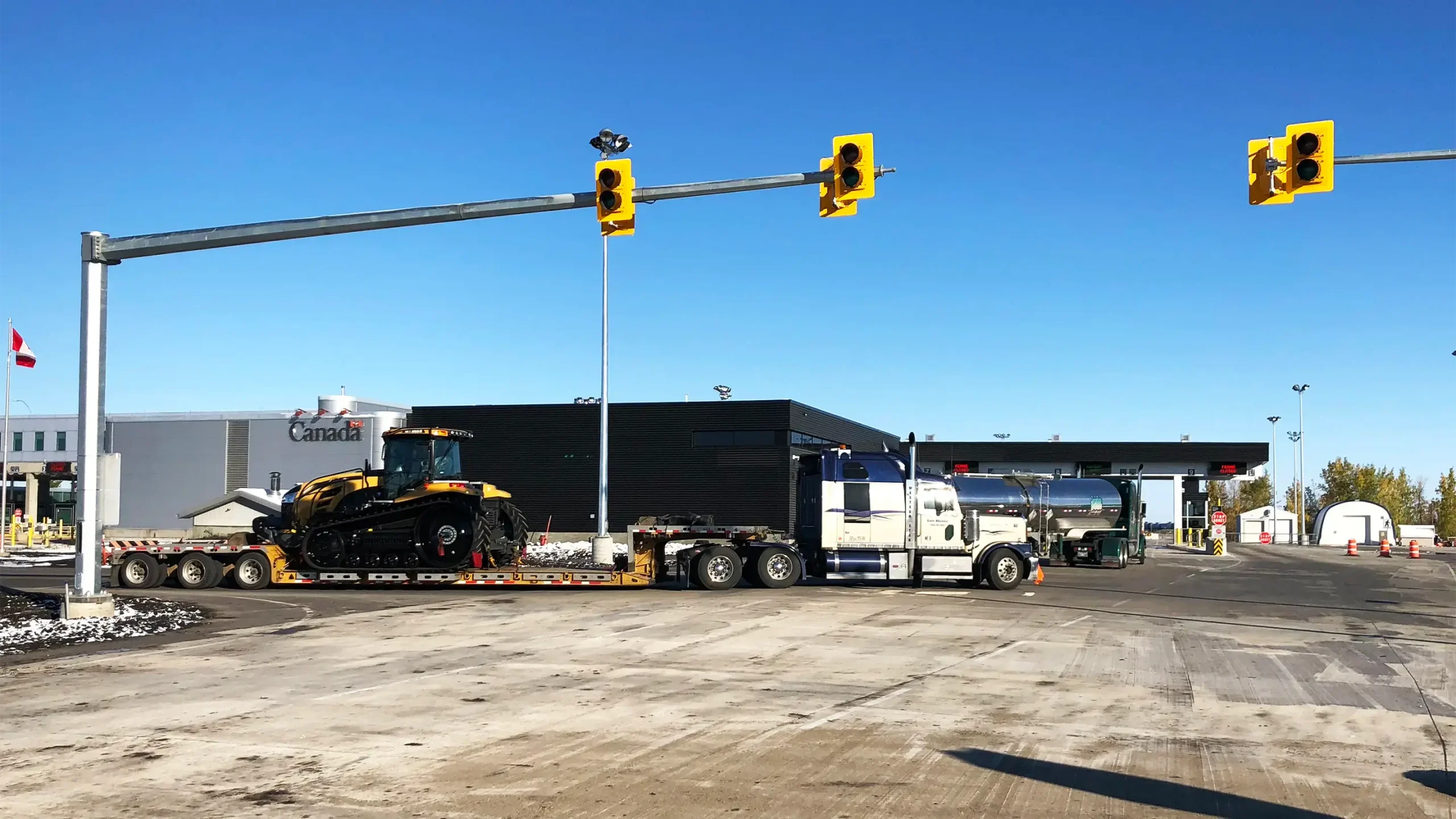Border crossing building with transport trucks in front