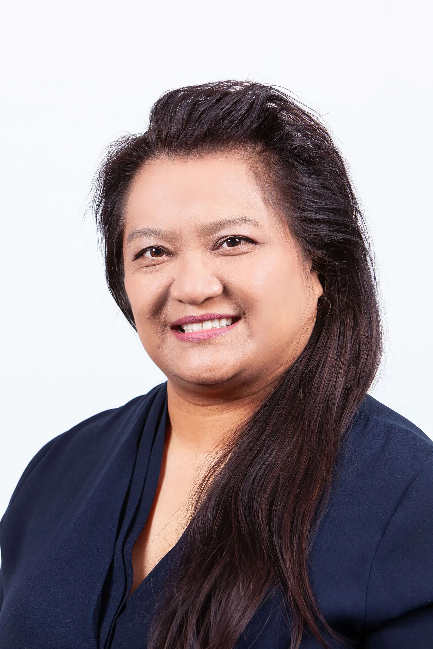 Professional headshot of a person smiling at the camera against a white background.