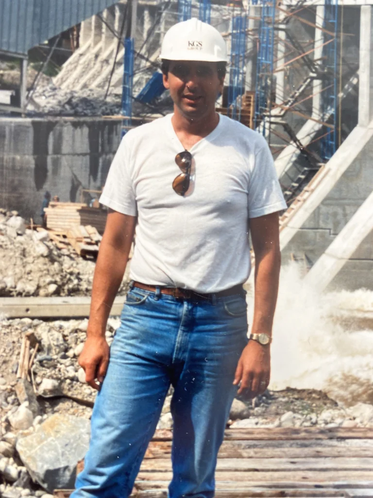 Man standing in front of dam under construction