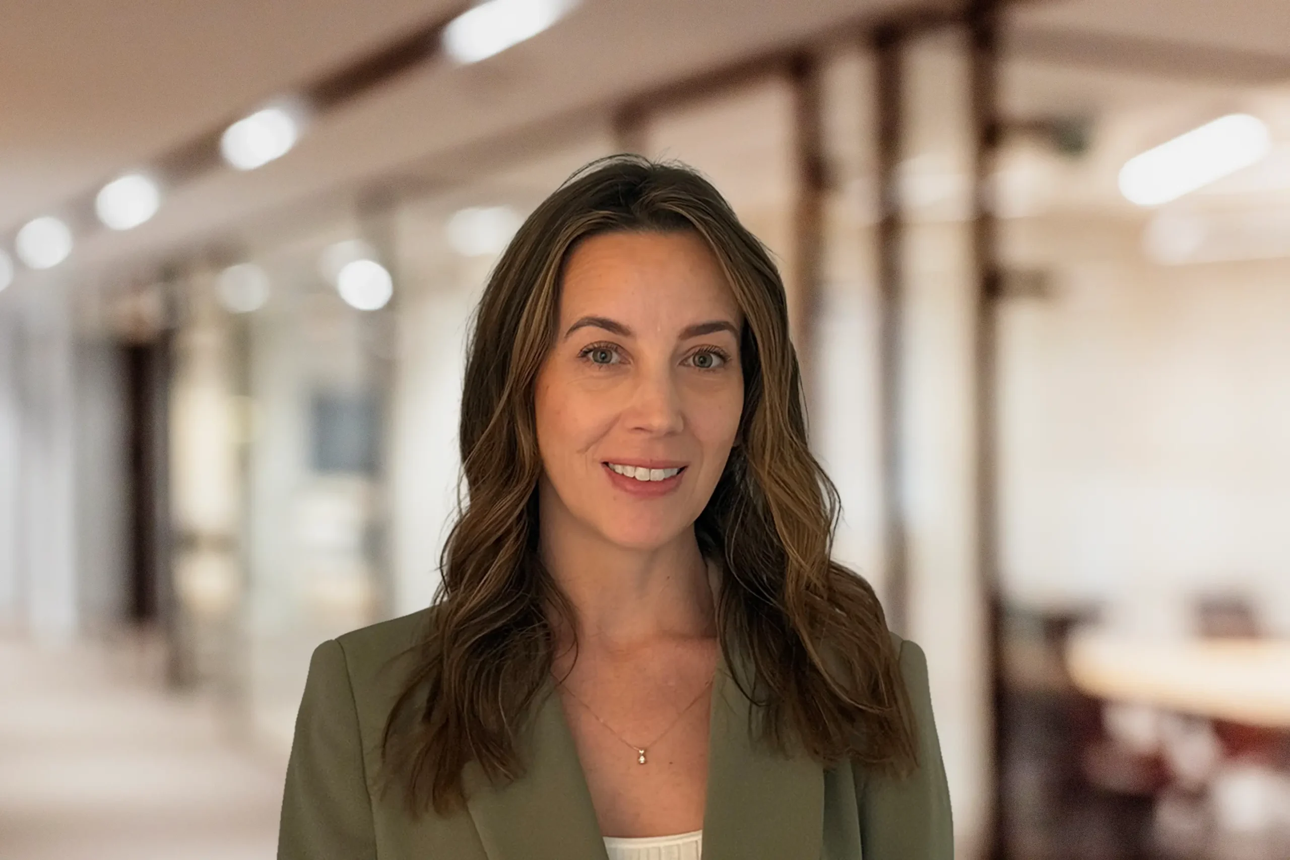 Woman standing in front of office backdrop