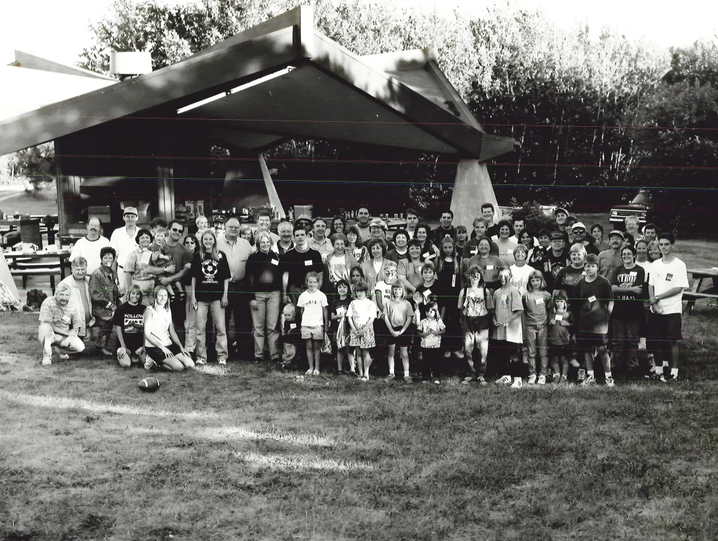 Group of people standing in front of picnic structure outdoors