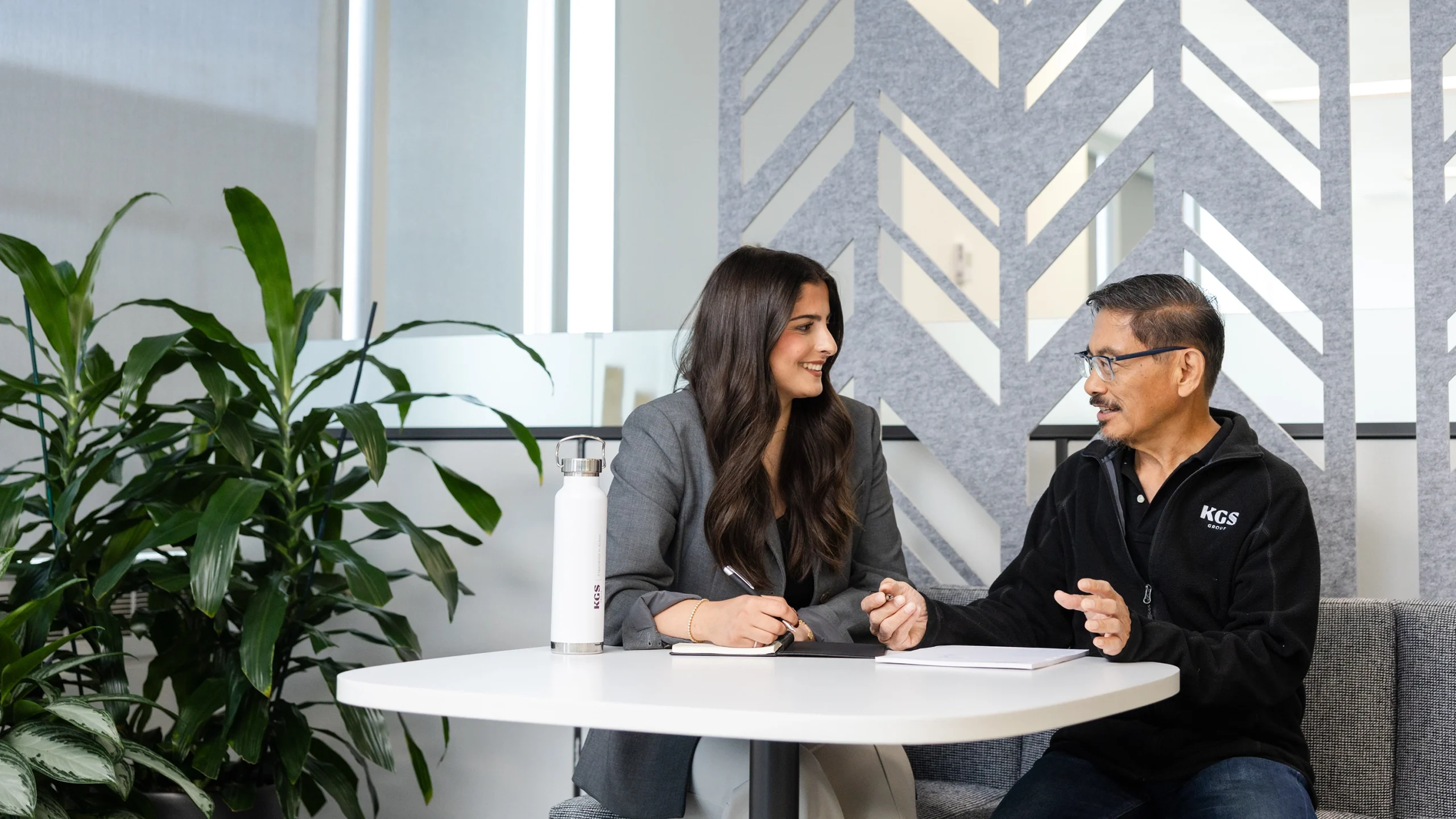two people sitting at a table collaborating